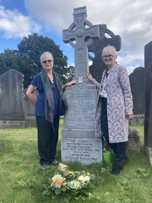 Two proud granddaughters of John Forrestal - cousins Dr Anne Forrestal author of Fierce Tears Frail Deeds (2021), and Dr Eileen Forrestal author of The Courage To Shine (2021) stand at his grave in Glasnevin, Dublin.